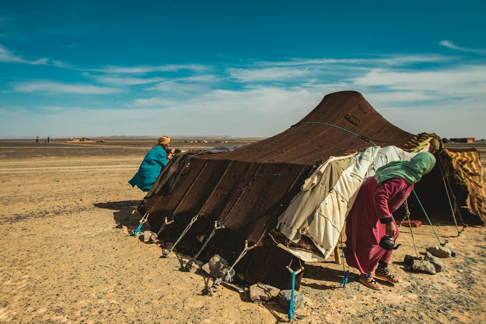 A traditional nomadic tent in the sandy expanse of Merzouga, Morocco.