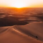Majestic sunrise over the dunes of the Sahara Desert in Morocco.