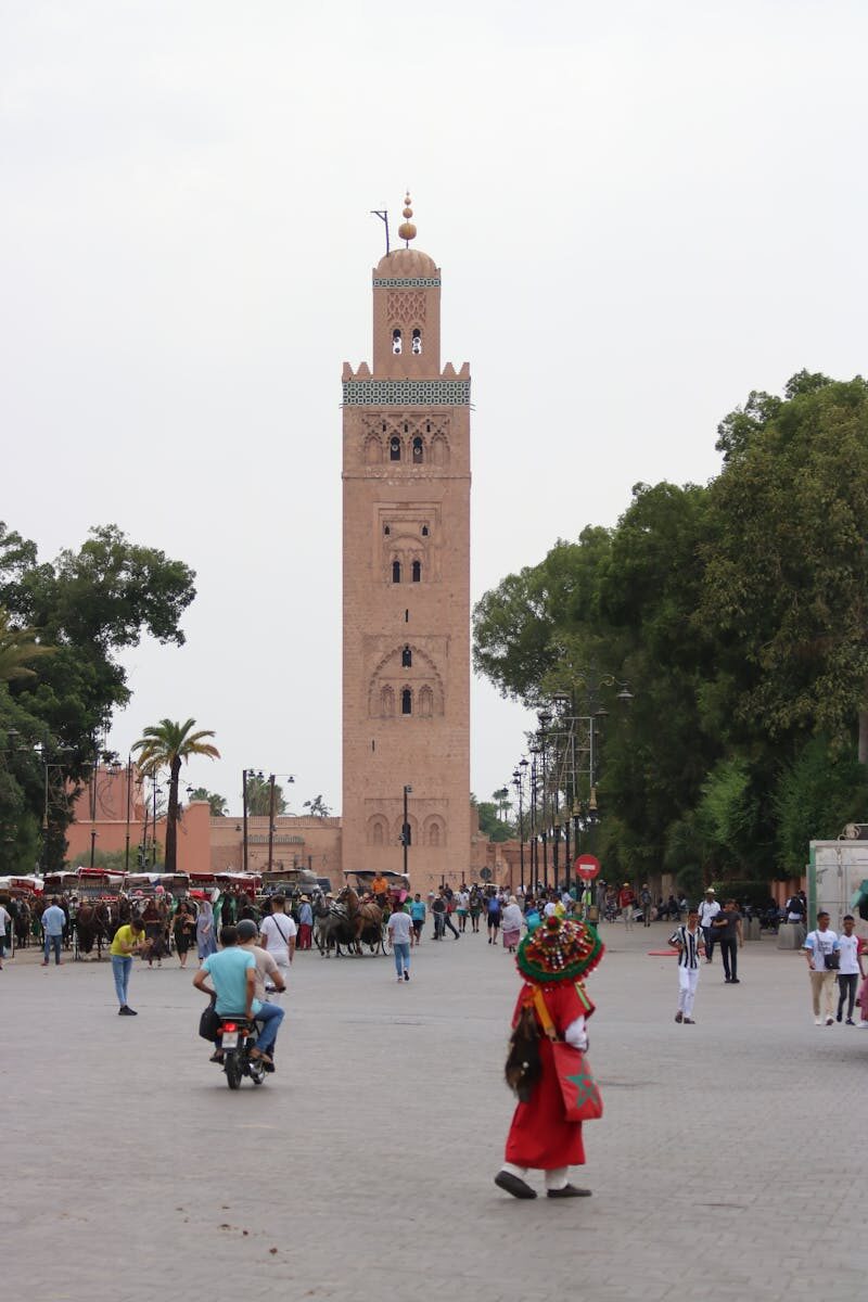 A vibrant scene near Koutoubia Mosque in Marrakesh, capturing local culture and architecture.