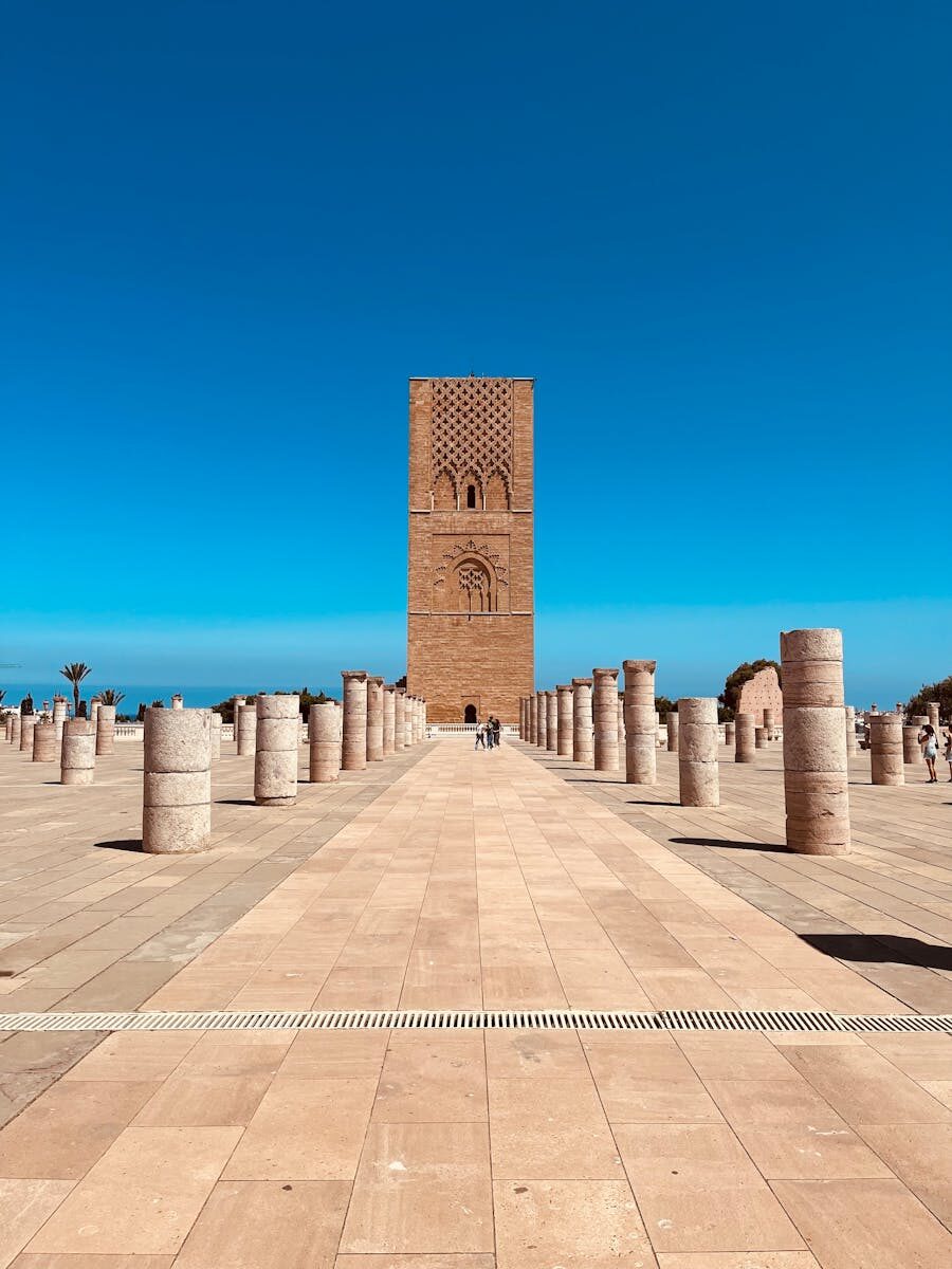 Scenic view of Hassan Tower surrounded by columns in Rabat, Morocco under a clear blue sky.