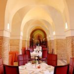 Luxurious dining area in Marrakech with elegant arches and decor. Perfect for fine dining experiences.