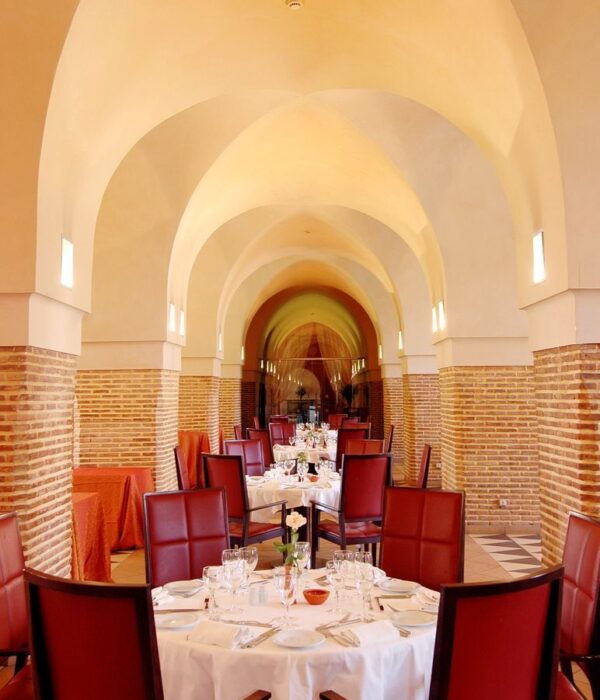 Photo by Morocco Vacation Trips Luxurious dining area in Marrakech with elegant arches and decor. Perfect for fine dining experiences.