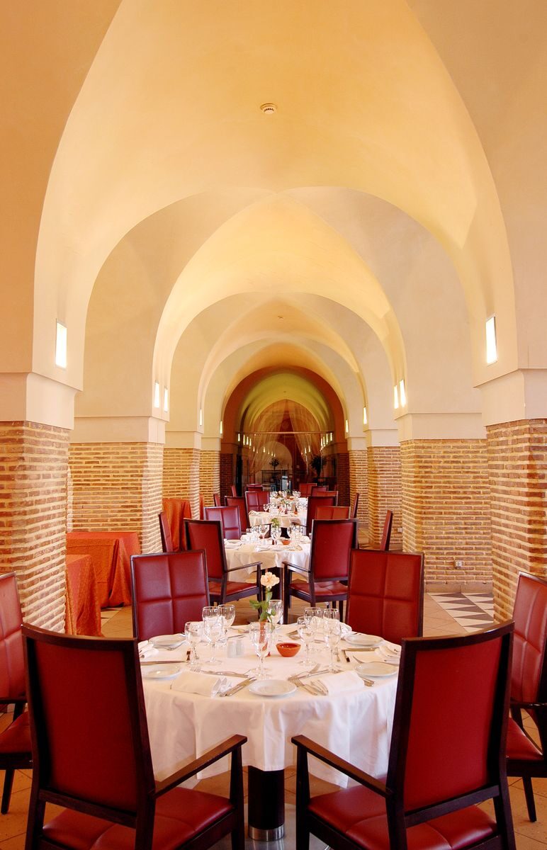 Luxurious dining area in Marrakech with elegant arches and decor. Perfect for fine dining experiences.