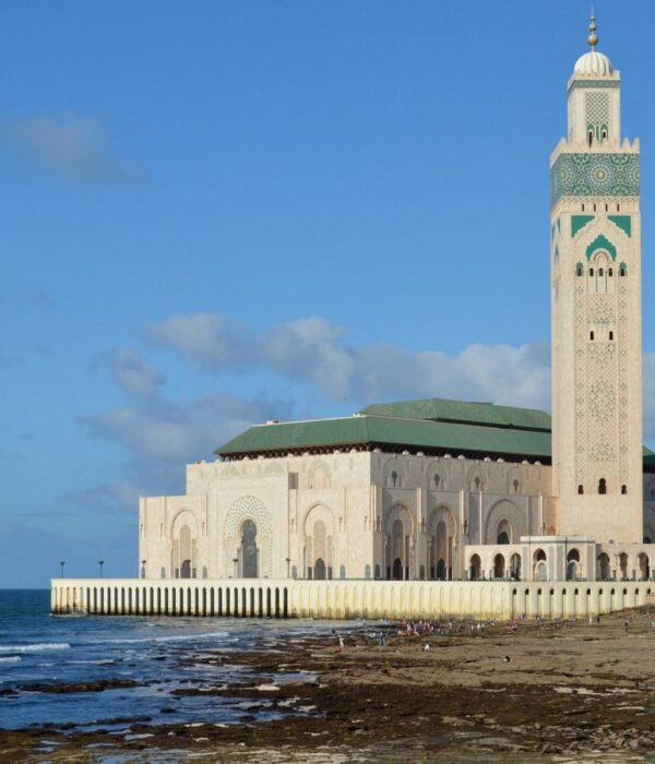 Photo by Morocco Vacation Trips Stunning view of the Hassan II Mosque in Casablanca by the Atlantic coast under a clear blue sky.
